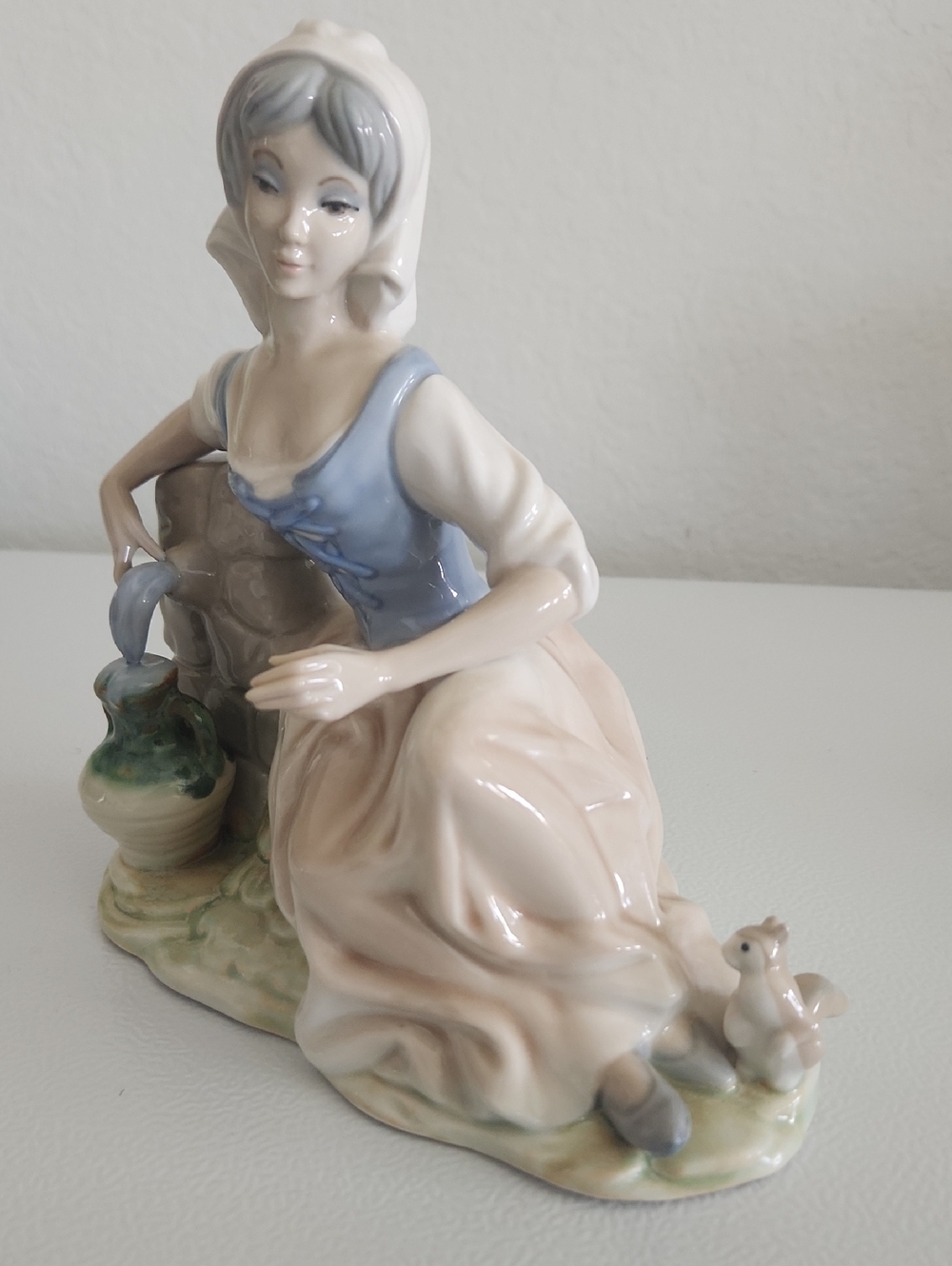 Porcelain Figurine of Woman in Blue Bodice and Cream Skirt
